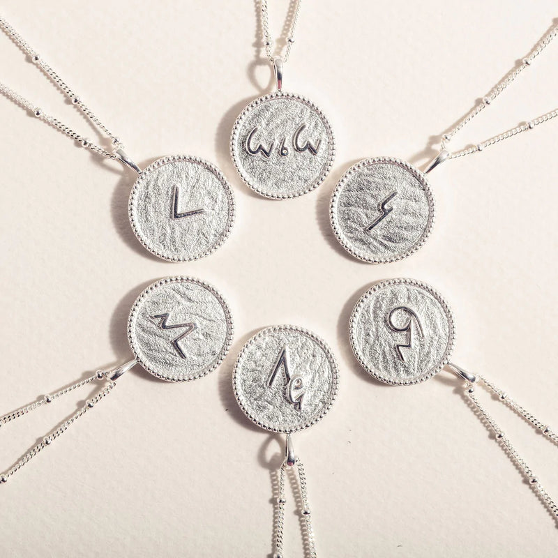 "THRIVE" SHORTHAND SILVER COIN NECKLACE
